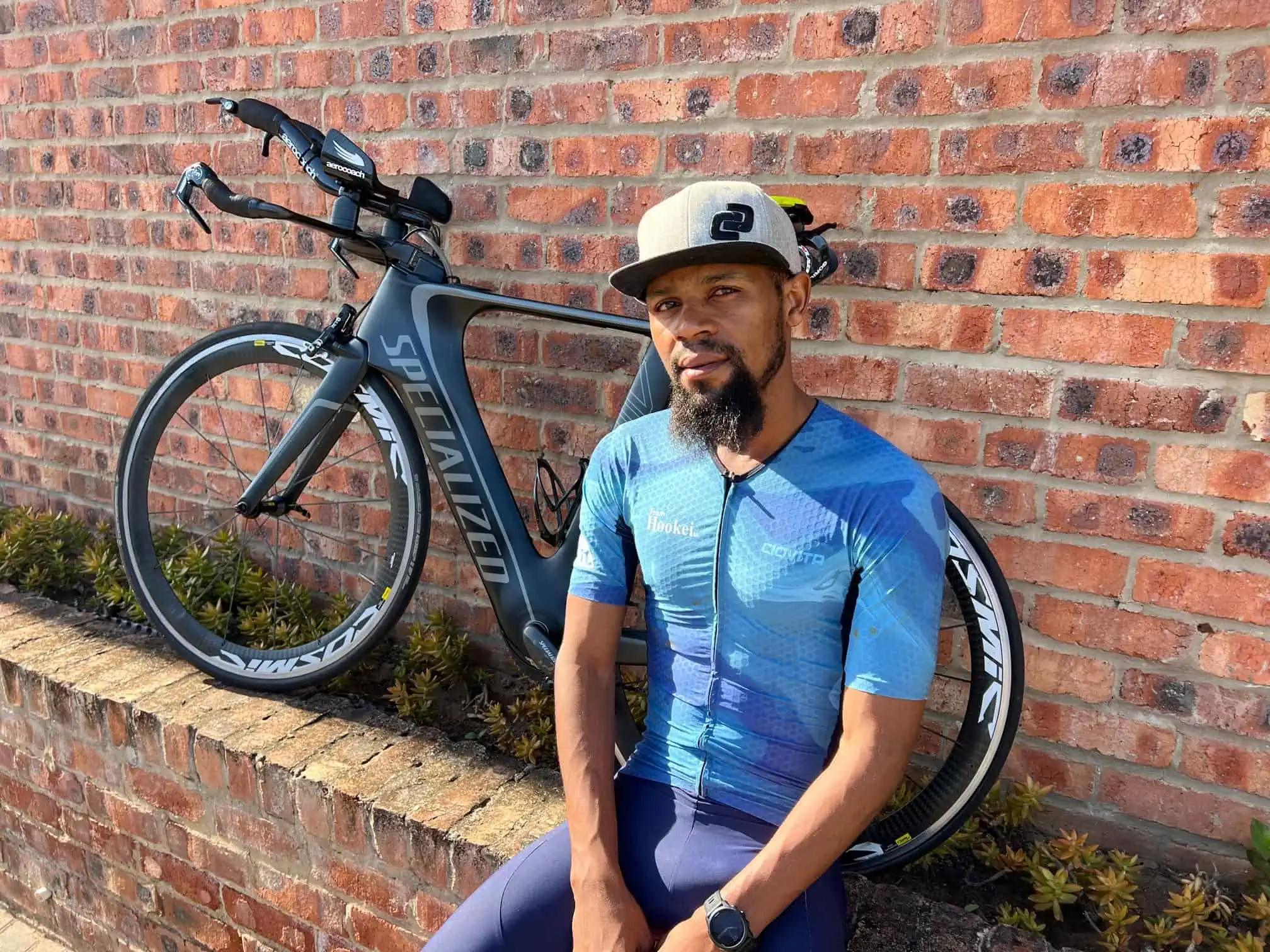 Sanele seated beside his time trial bike
